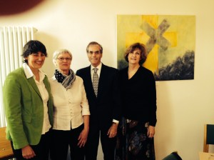 (L to R) Pastorin Martina Dittkrist, artist Hannlore Golberg, me, and Vickie standing in front of Ms Golberg's painting of "The Broken Cross" symbolizing the ongoing atonement of the community of the Michaeliskirche in Kaltenkirchen for the crimes of their one time Pastor Ernst Biberstein who was tried and convicted at Nuremberg of mass murder.